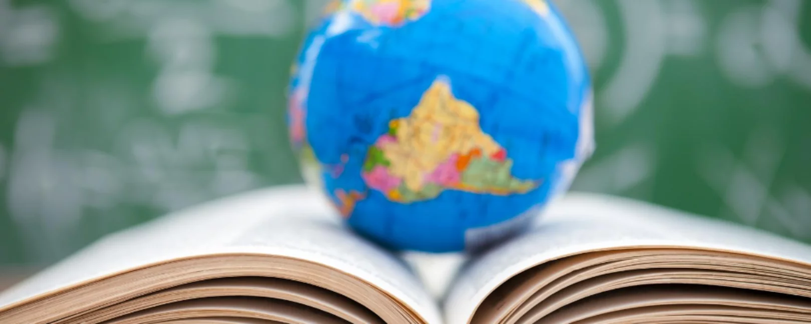 World globe standing on open book