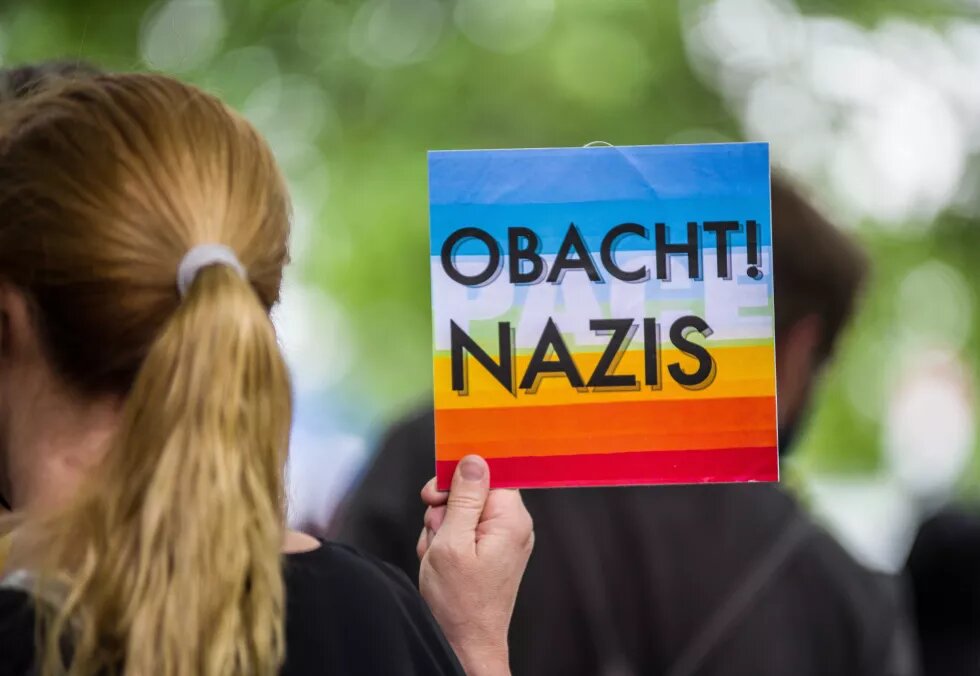 July 18, 2020, Munich, Bavaria, Germany: ''Careful...nazis!'' held by a demonstrator against the neonazi NPD party in Munich. After a pause due in part to the Coronavirus crisis and political losses from members and associates such as Karl Richter, six from the neonazi NPD party resurfaced at Munich`s Rotkreuzplatz with up to 100 counterdemonstrators against them. The party brought back their Migration Toetet (Migration Kills) slogan back during the demonstration and has promised more 